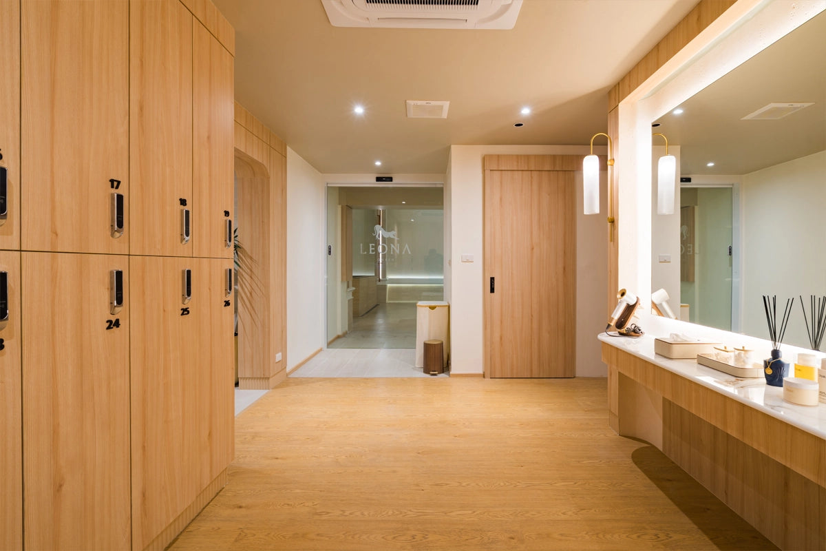 Modern bathroom with lockers and a large mirror at Leona Onsen.