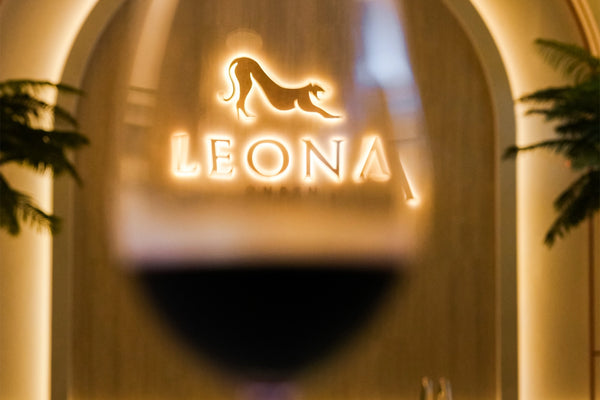 A glass of red wine beside an onsen pool at Leona Onsen, Bangkok.