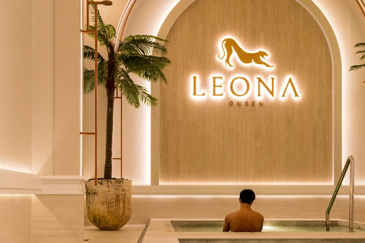 A gentleman in an onsen pool in a luxury setting.