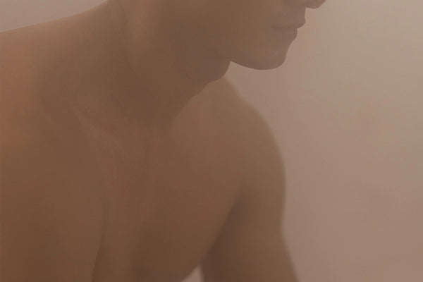A man sitting in a steam room with aroma scent at Leona Onsen, Bangkok.