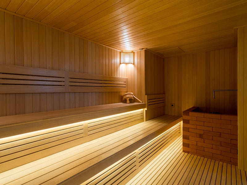 Wooden sauna interior with benches at Leona Onsen, Bangkok.